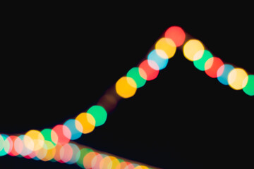 Festive multicolored bokeh. Dark background and multicolored circles.