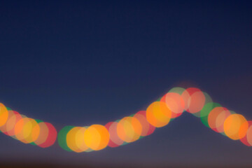 Festive multicolored bokeh. Dark background and multicolored circles.