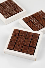 Assortment of chocolate candies in white boxes