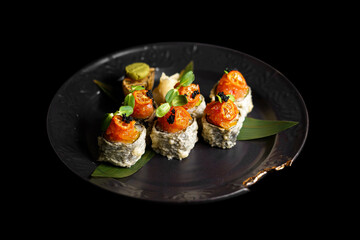 Sushi on a black art plate and black background