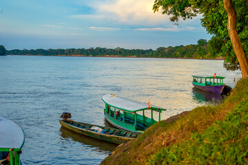 Peru, Amazonas, the large Rio Madre. Small ferry boats for crossing the river during sunset.