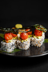 Sushi on a black art plate and black background