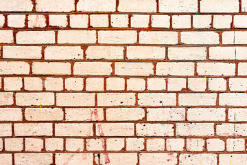 Texture of a brick wall with cracks and scratches which can be used as a background