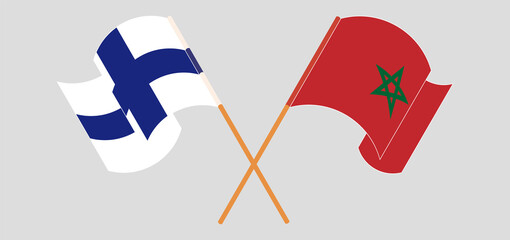 Crossed and waving flags of Finland and Morocco