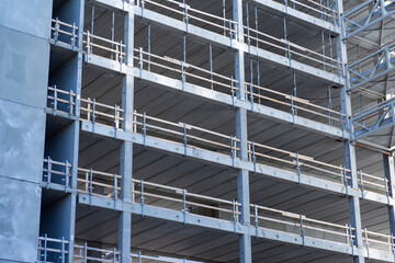 Fragment background of a skyscraper contruction with several concrete floors without floors and...