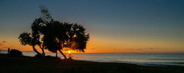 Fototapeta na wymiar Vivid and dynamic sunrises at beaches on Oahu Hawaii tropical serene ocean scenes and island breezes.