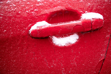 the car is frozen. the door handles are icy. frost. the car is covered with ice under the snow. background
