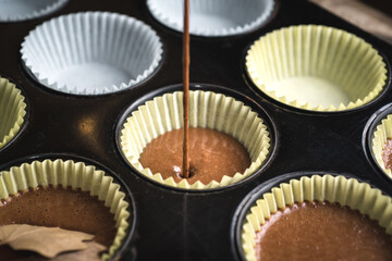 Pouring Cake batter into cupcake pan