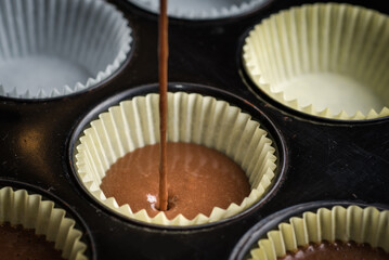 Pouring Cake batter into cupcake pan