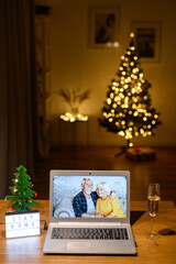 Video call to grandparents at Christmas. Virtual meeting with a senior couple grandmother and grandfather. Celebration holidays on the distance due to lockdown, quarantine