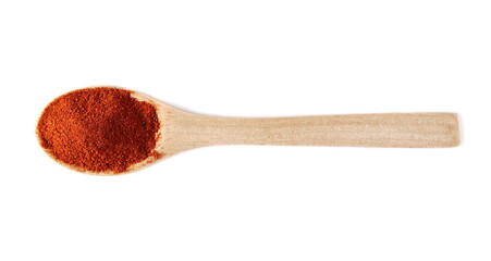 Red paprika powder pile with wooden spoon isolated on white background, top view