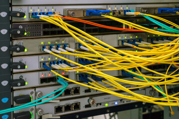 There are many fiber optic wires connected to the central router interfaces. High-speed internet equipment works in the server room. room.