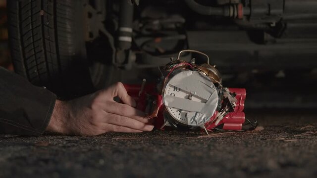 putting time bomb under car