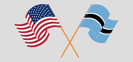 Crossed and waving flags of the USA and Botswana