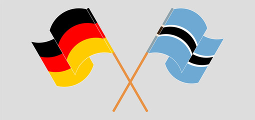 Crossed and waving flags of Germany and Botswana