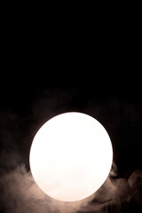 Mystical stylish smoke on a black background with reflection in a round mirror. Smoking, hookah and vaping concept. Copy space background