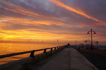 Naklejka na ściany i meble Key west pier at sunrise with street lamps and birds