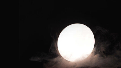 Mystical stylish smoke on a black background with reflection in a round mirror. Smoking, hookah and vaping concept. Copy space background