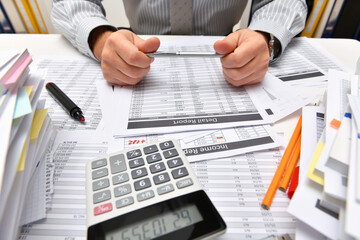 business concept - businessman working with reports in office, table and workspace close view,...
