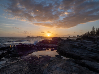 Fototapeta na wymiar Beautiful Seaside Sunrise with Rock Pool Cloud Reflections