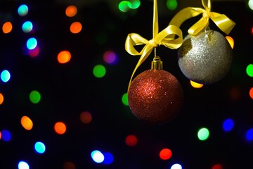 two christmas balls on a dark background