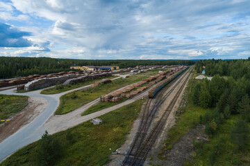 Hyrynsalmi railway yard with log wood waiting for railway transport to saw mills, Finland - 398960022