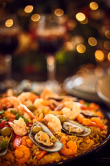 Naklejka premium Spanish dinner table with assortment of dishes. paella, octopus, whole fish, sangría and wine. Dressed for christmas