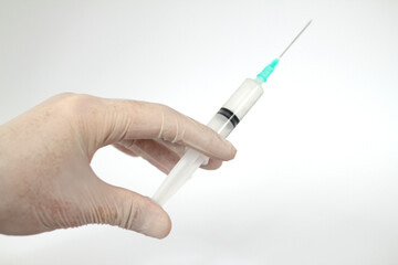 Medicine plastic vaccination equipment with needle in doctor or nurse hand isolated on white background. Health care concept. Hand holding syringe and vaccine. Injection syringe isolated.