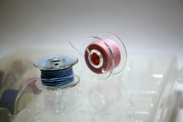 Blue thread wound on a bobbin.