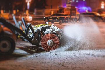 Process of snow removal on the city streets and roads with municipal vehicle, bulldozer, snowblower...