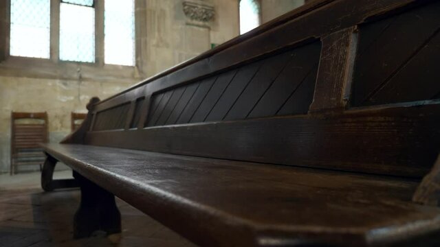 Empty Old Wooden Bench At Ancient Stone Cathedral. Medieval Gothic Architecture Interior