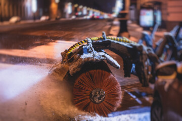Process of snow removal on the city streets and roads with municipal vehicle, bulldozer, snowblower plow truck, snowplow, snow removal equipment in winter night