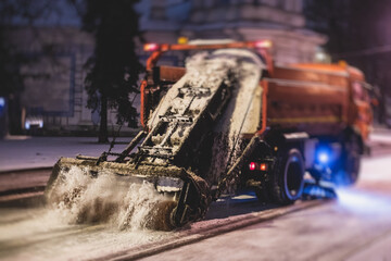 Process of snow removal on the city streets and roads with municipal vehicle, bulldozer, snowblower...