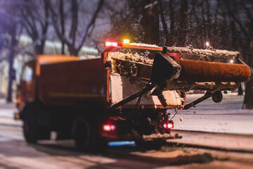 Process of snow removal on the city streets and roads with municipal vehicle, bulldozer, snowblower...