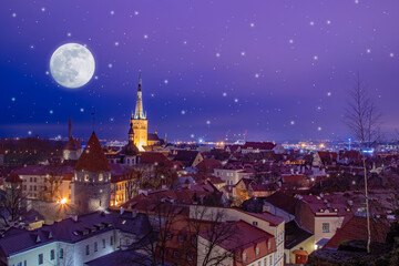 A winter fairy tale aerial cityscape of a town with medieval towers, church, snowfall and moon in the night