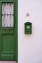 Green door and antique mailbox of a white traditional house in old Nicosia, Cyprus