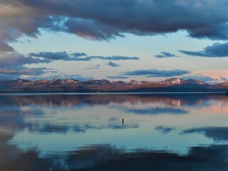 Reflections in the still mirror waters of Yellowstone National Park Wyoming USA beautiful sky as above so below