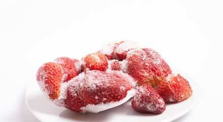 Frozen foods: strawberries. On a white table. Berry background.