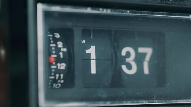 Vintage retro flip clock with the time advancing at a very fast pace showing how time passes fast. Old-style radio analog clock.