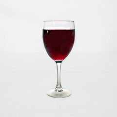 glass of red wine on a white background.