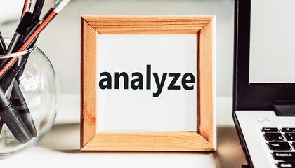 Analyze text in wooden frame on office table.