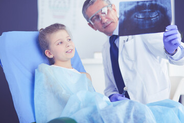 Little girl sitting in the dentists office