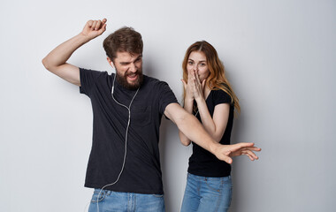 young couple in headphones technology music fun studio isolated background