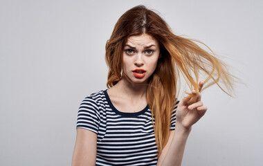 stylish woman in striped t-shirt holding hair hairstyle smile