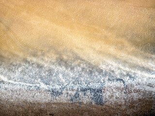 The sand and salt crystals formed a beautiful texture. View of the salt marsh at noon