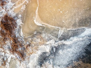 The sand and salt crystals formed a beautiful texture. View of the salt marsh at noon