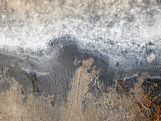 The sand and salt crystals formed a beautiful texture. View of the salt marsh at noon