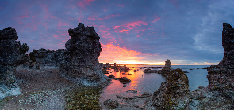 Typical limestone rocks from Gotland. They are called rauks or rauk-fields. Sunrise over the Baltic Sea.