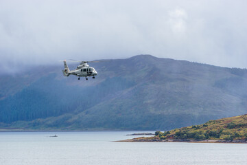 Helicopter flying over sea near scottish island skye