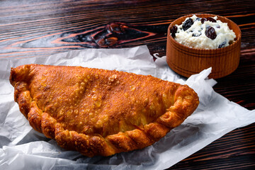 Fresh homemade bun with cottage cheese, pie with cottage cheese and raisins